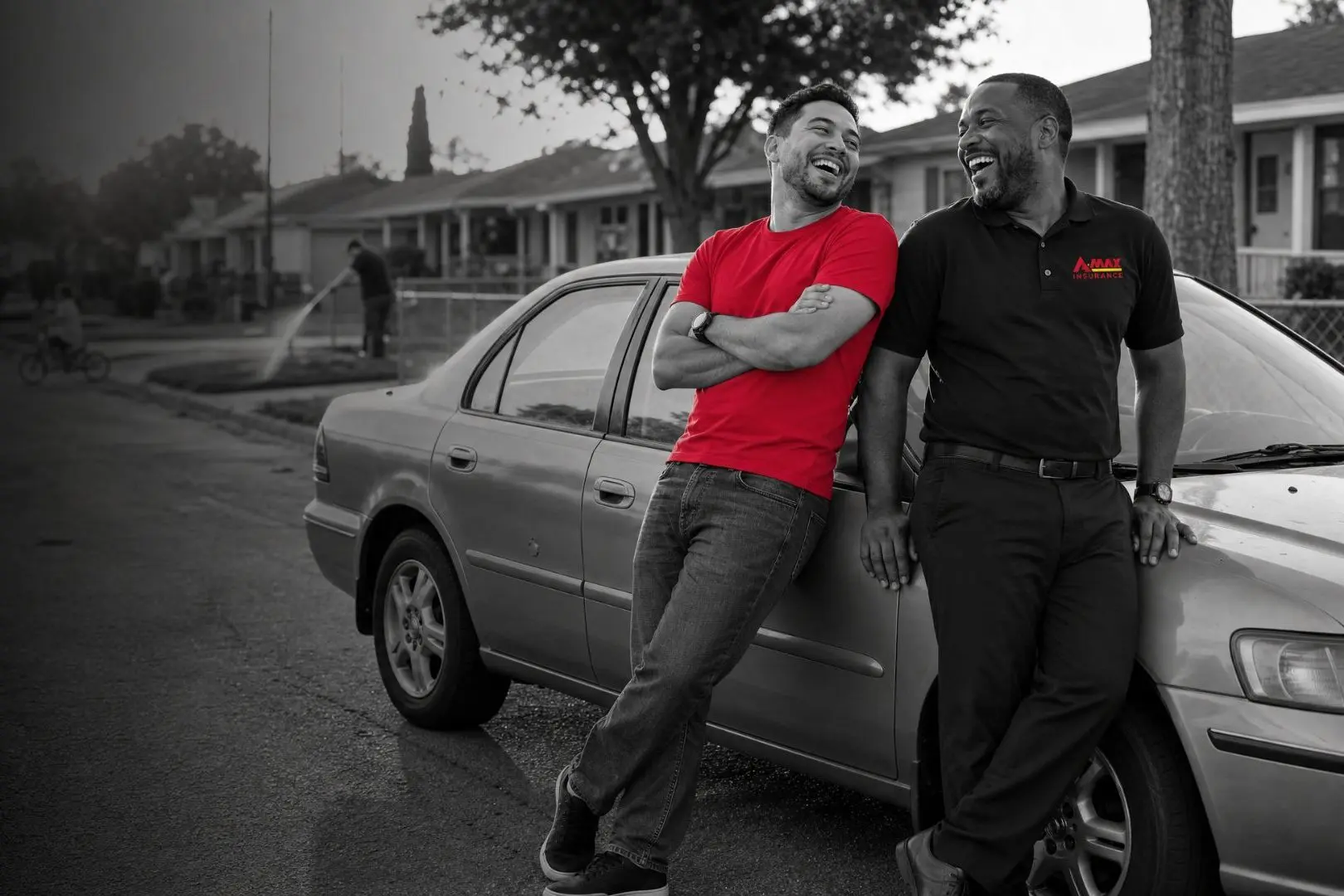 A customer leaning on his car beside an A-MAX agent
