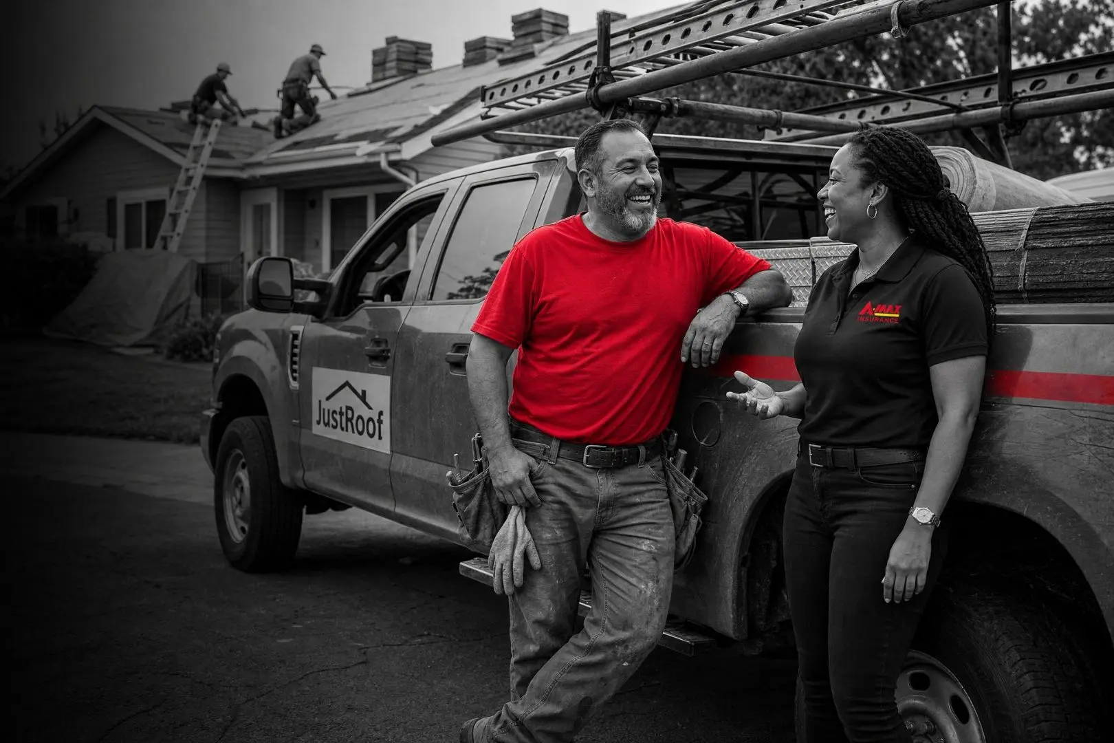 A business owner leaning on his work truck with an A-MAX agent