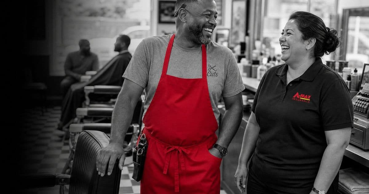 A business owner in an apron talking with an A-MAX agent in her shop
