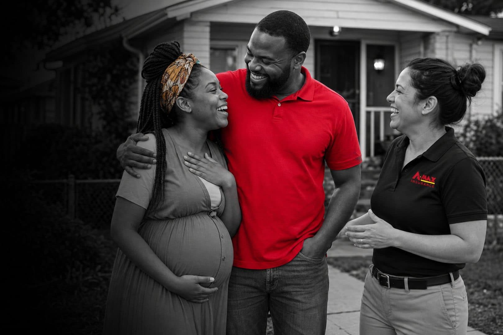 An expecting couple talking with an A-MAX agent outside their home