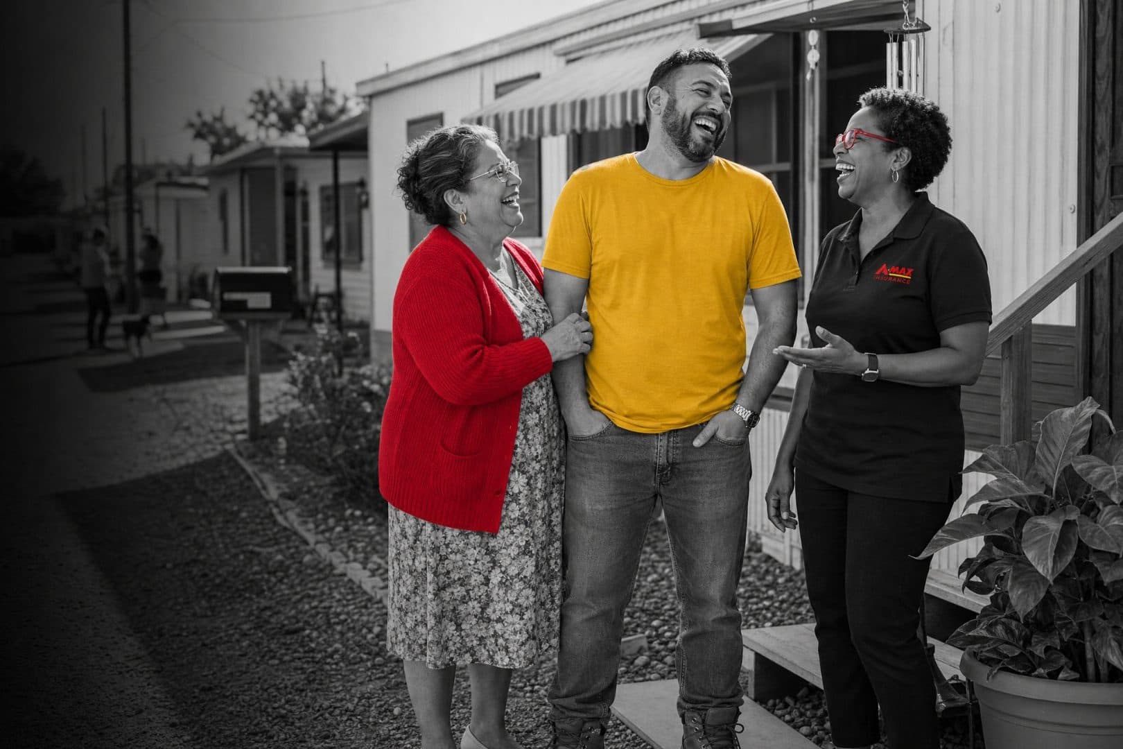 A family talking with an A-MAX agent outside their mobile home