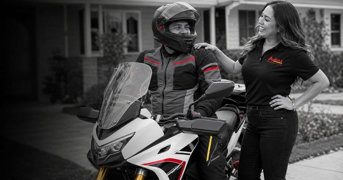 A motorcycle rider talking with an A-MAX agent