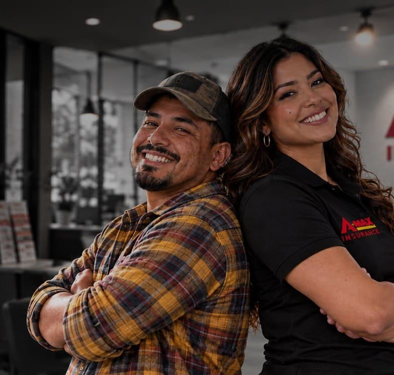A smiling A-MAX customer and an A-MAX agent standing back to back in an A-MAX office